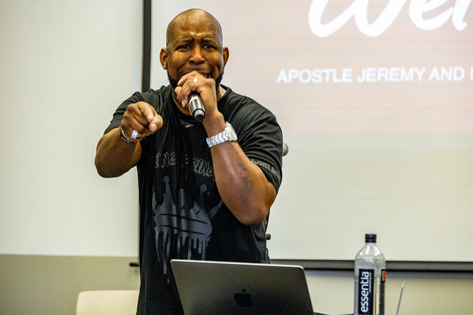Jeremy Gibson preaching, pointing toward the congregation